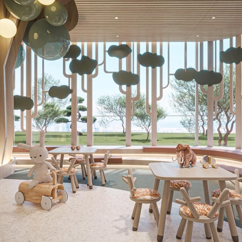 Espace ludique intérieur pour enfants au projet Cybel by Wadan avec mobilier en bois et vue sur les jardins